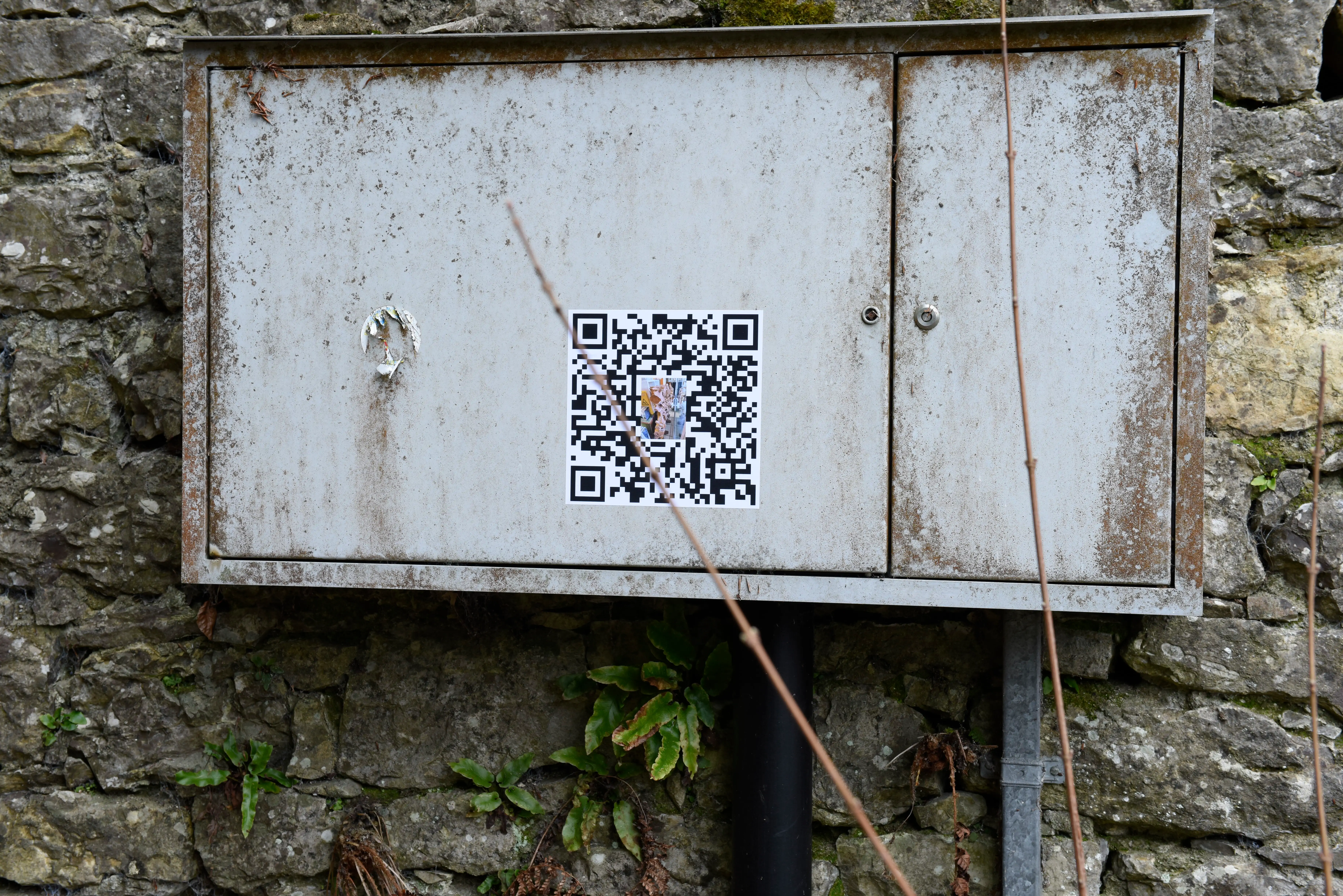 electricity box with destroyed sticker and QR code