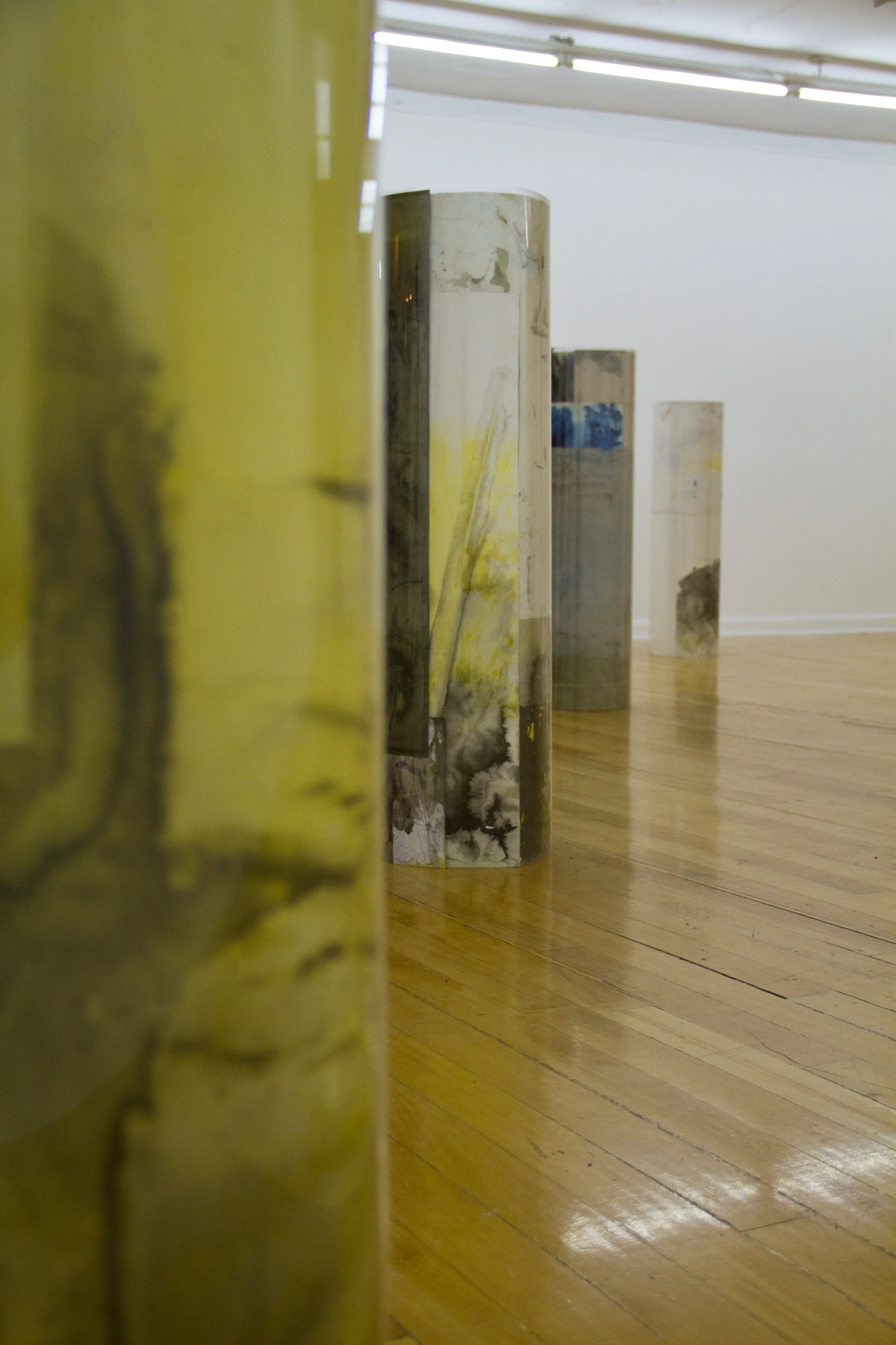 Installation view, the tube like sculptures seen from their side, detail